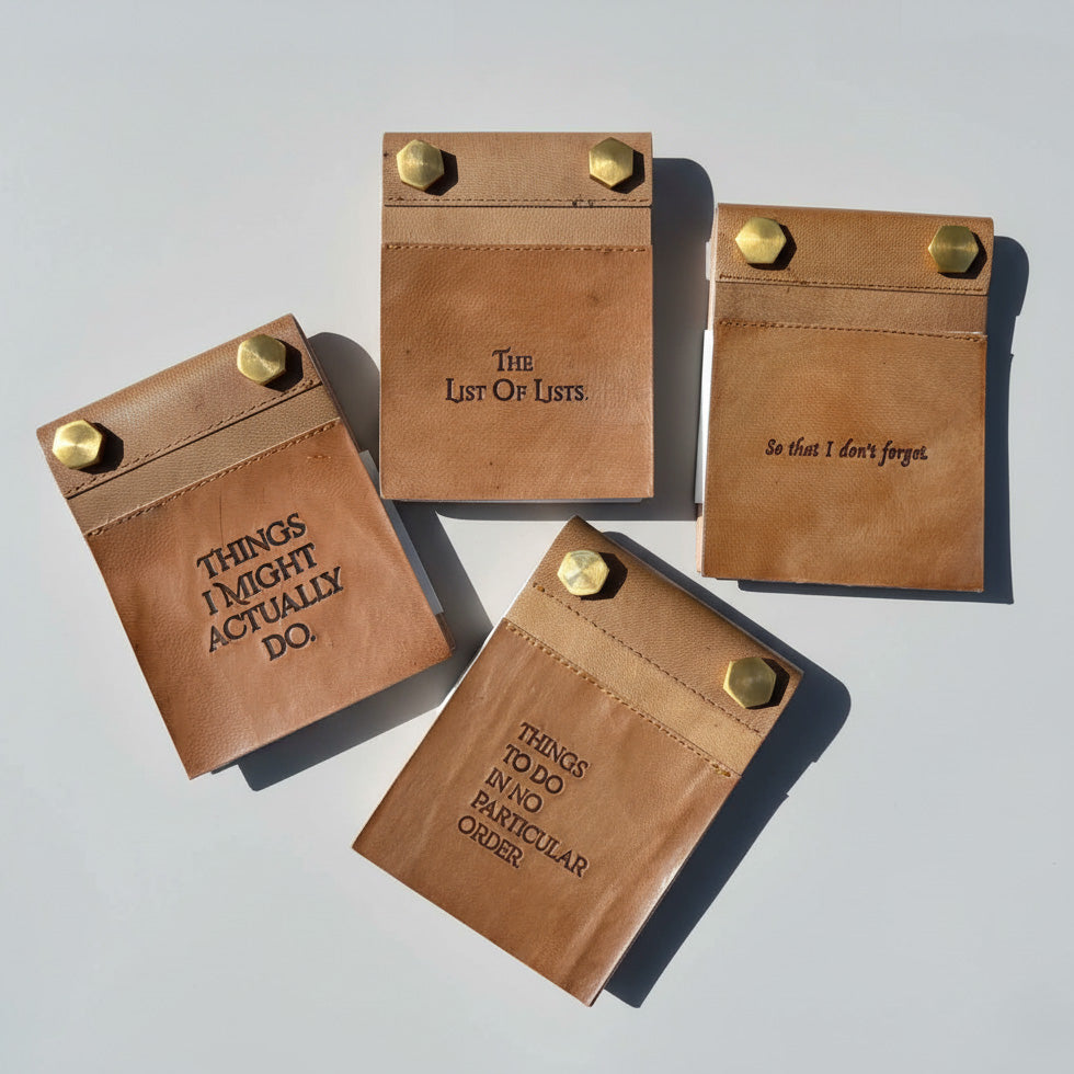 Four Soothi refillable leather notepads with different list titles