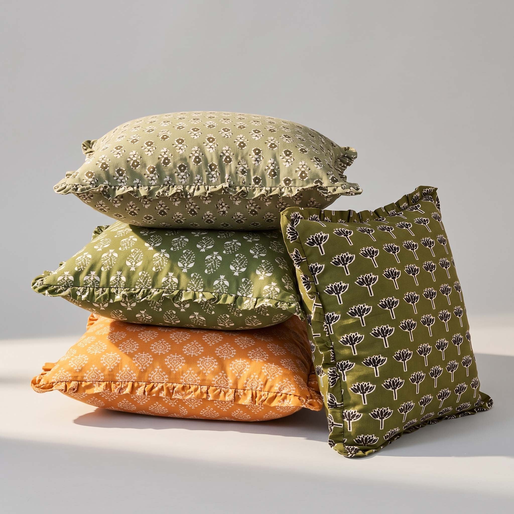 Stack of Soothi hand-block-printed ruffled pillow covers in three colorways