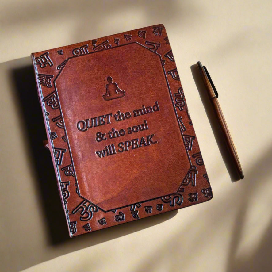 Brown leather notebook with embossed text on a brown background