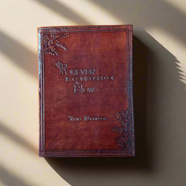 Brown leather-bound book with embossed design on a brown background