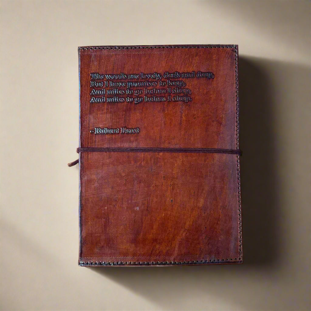Brown leather notebook with embossed text on a brown background