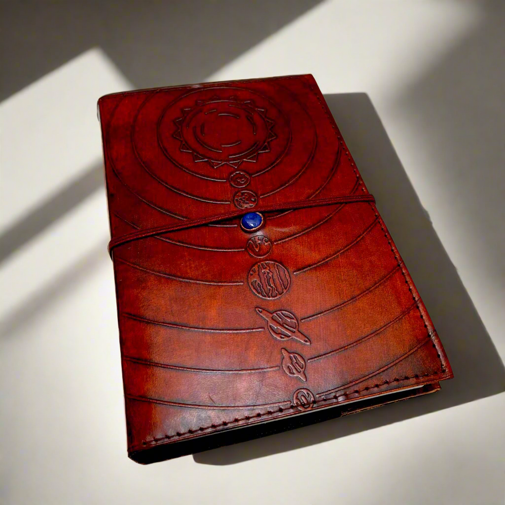 Space-themed leather notebook – embossed with galactic elements and adorned with a blue cobalt stone