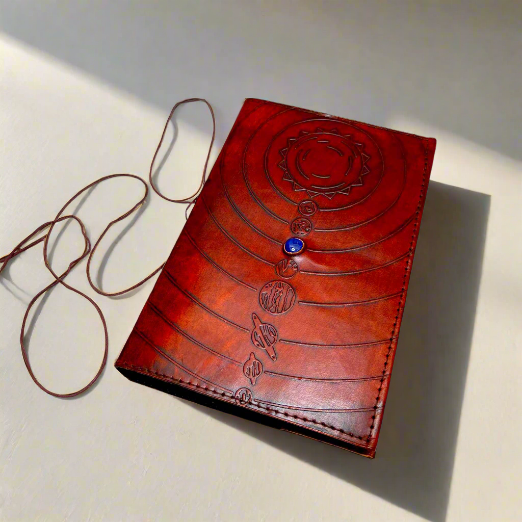 Space-themed leather notebook – embossed with galactic elements and adorned with a blue cobalt stone