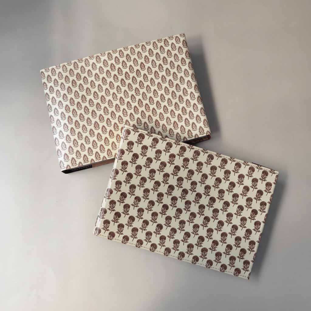 Two patterned boxes on a gray background