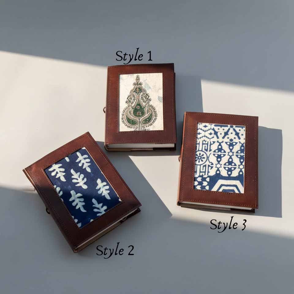 Close-up of three Legacy Patchwork artisan fabric leather journals showing texture and block-print details