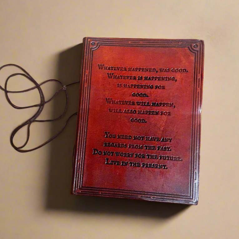 A handcrafted red leather journal with an embossed inspirational quote - dedicated space to process your thoughts, cultivate positivity, and reinforce