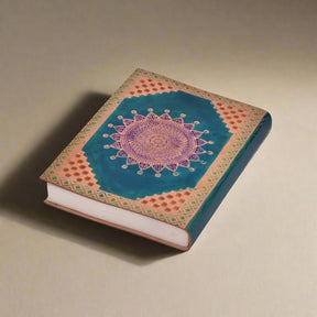 Decorative notebook with mandala design on a white background