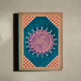 Decorative notebook with mandala design on a white background