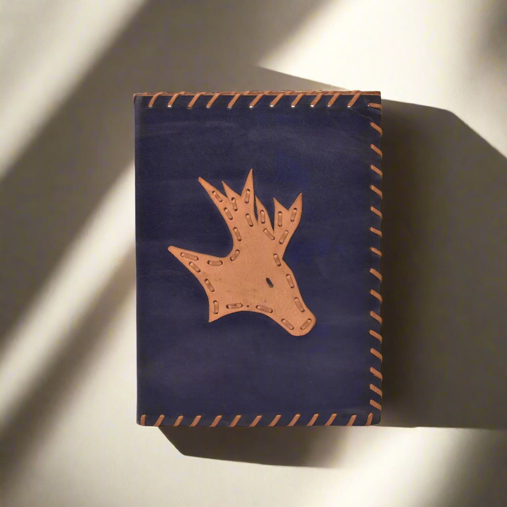 Navy blue leather pouch with brown deer head design on a white background