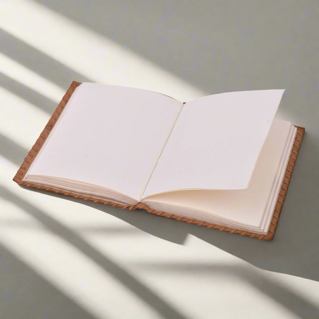 Open book with beige pages and brown binding on a white background