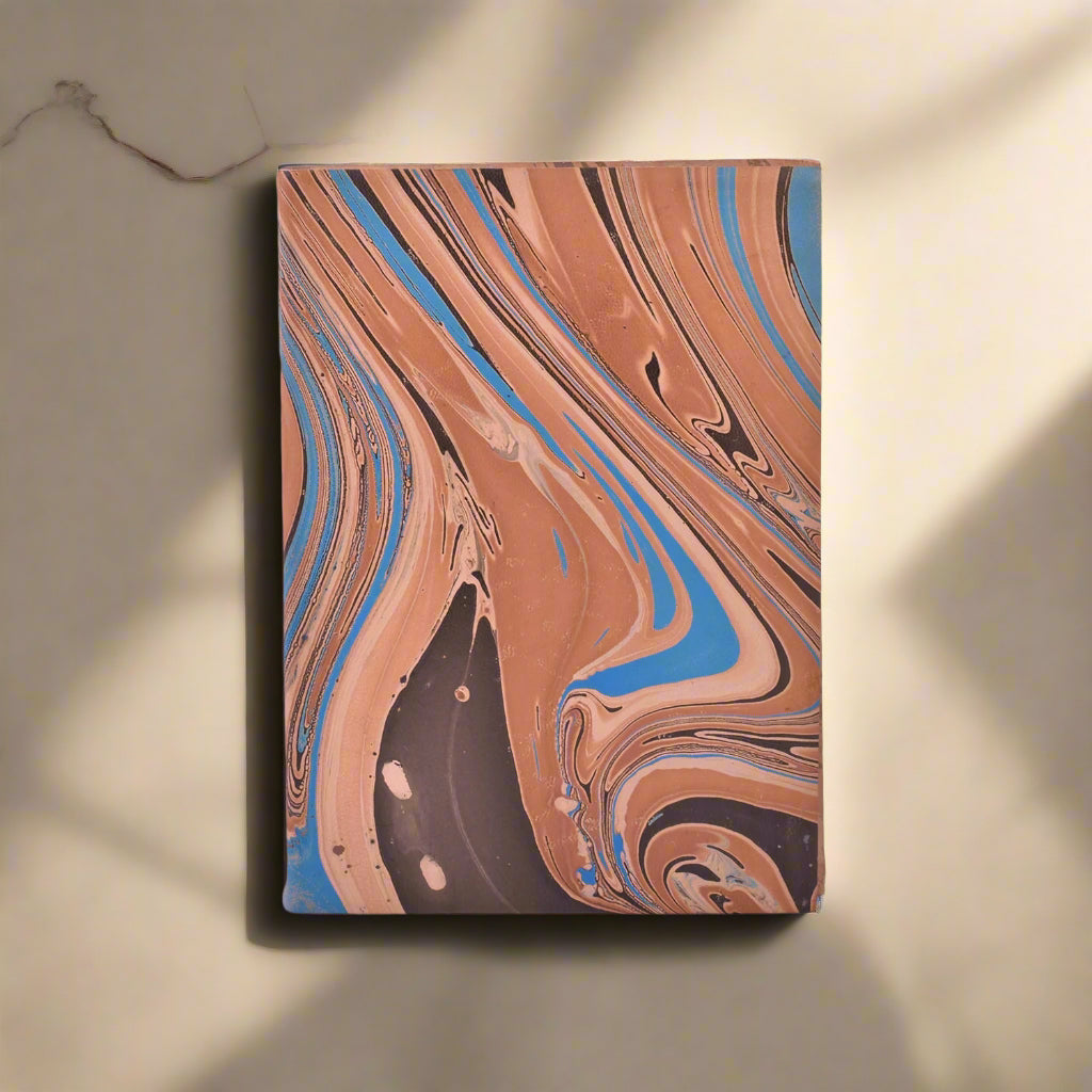 Notebook with marbled brown, blue, and black design on a white background