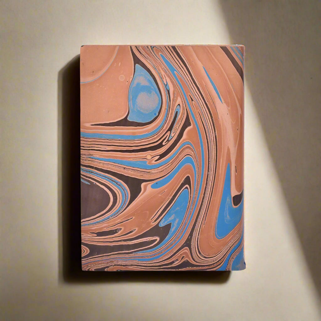 Notebook with marbled brown, blue, and black design on a white background
