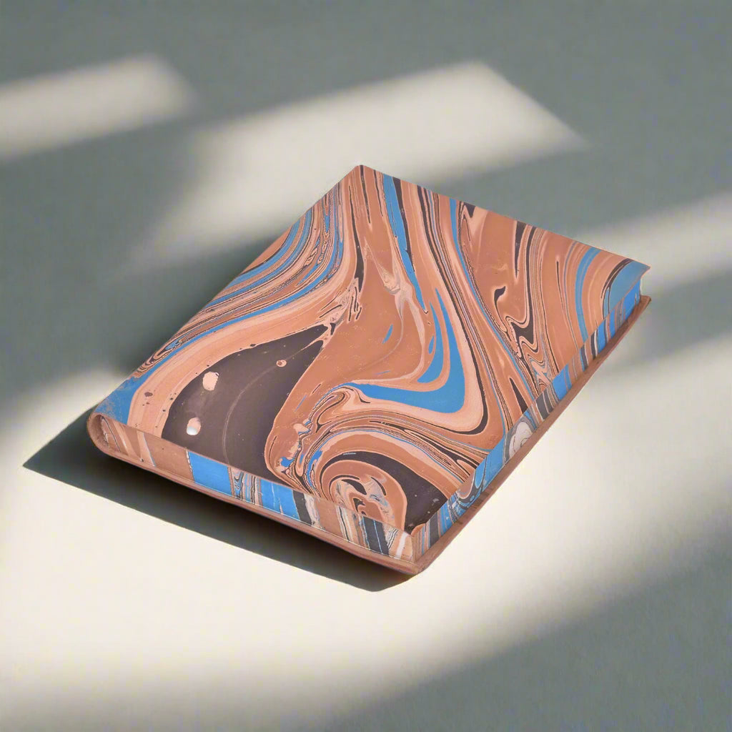 Marbled notebook with brown, blue, and beige colors on a white background