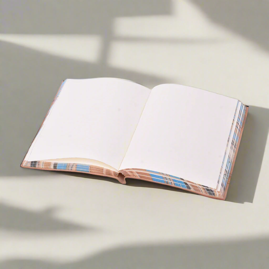 Open book with plaid binding on a white background