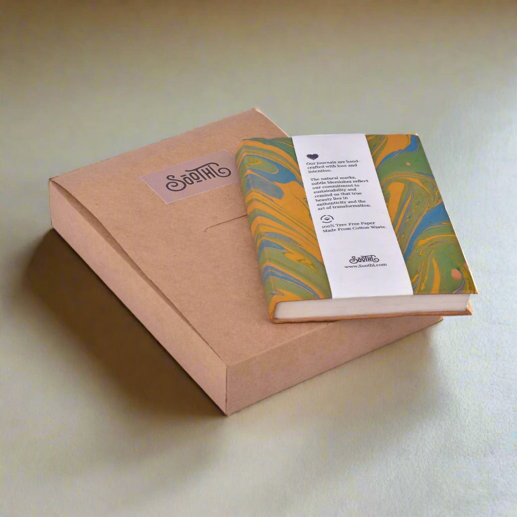 Marbled notebook with a label on a brown box against a white background