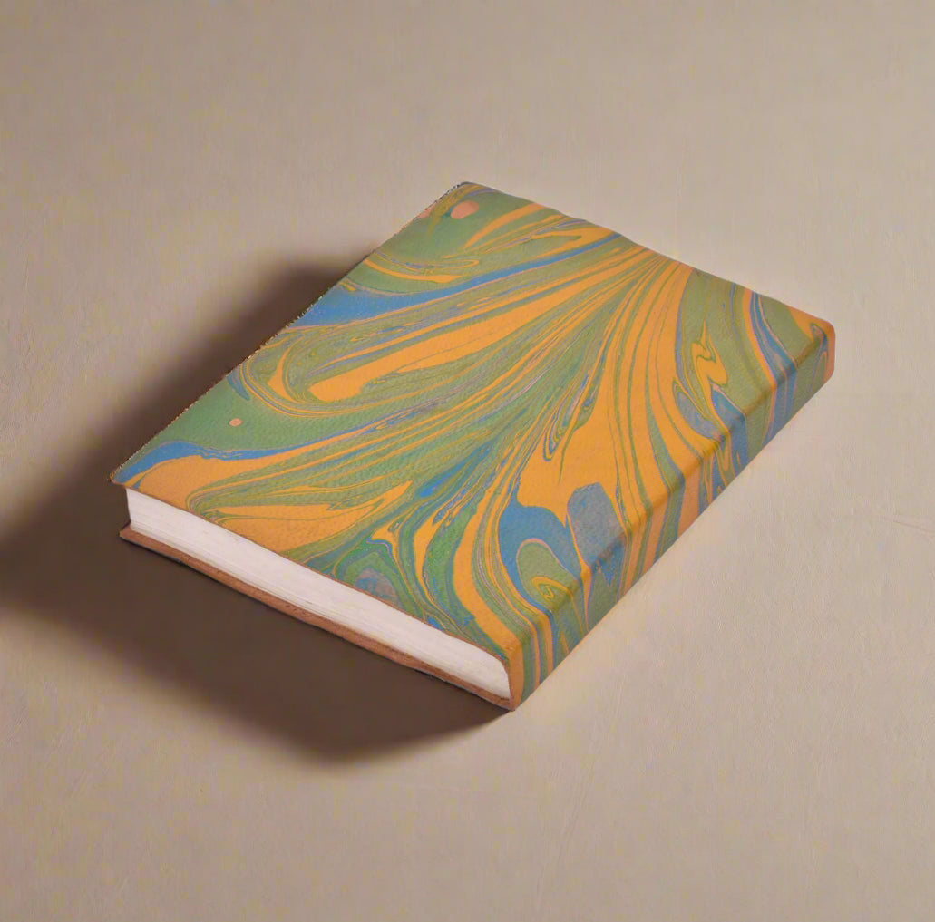 Marbled notebook with green, orange, and blue patterns on a white background