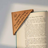 Open book with a leather bookmark on a gray background