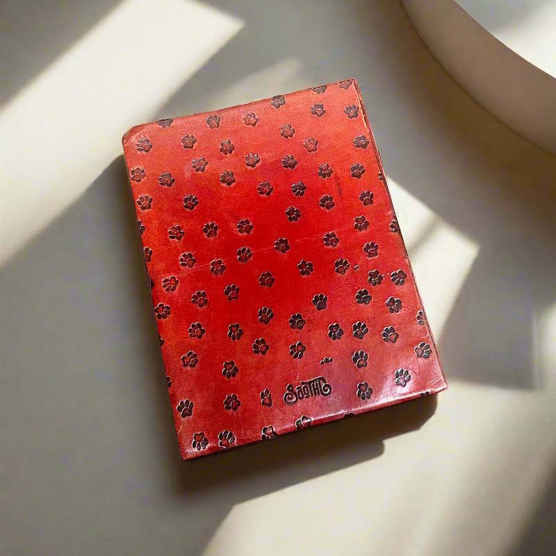 Charming leather journal - embossed with a playful fire hydrant and paw print details, alongside the inspiring quote design 