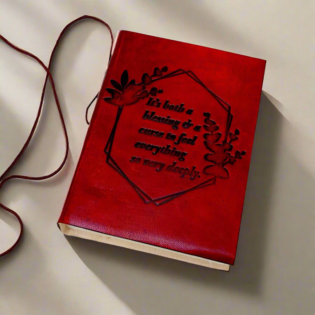 Close-up of embossed Feel Deeply quote on brown leather journal cover