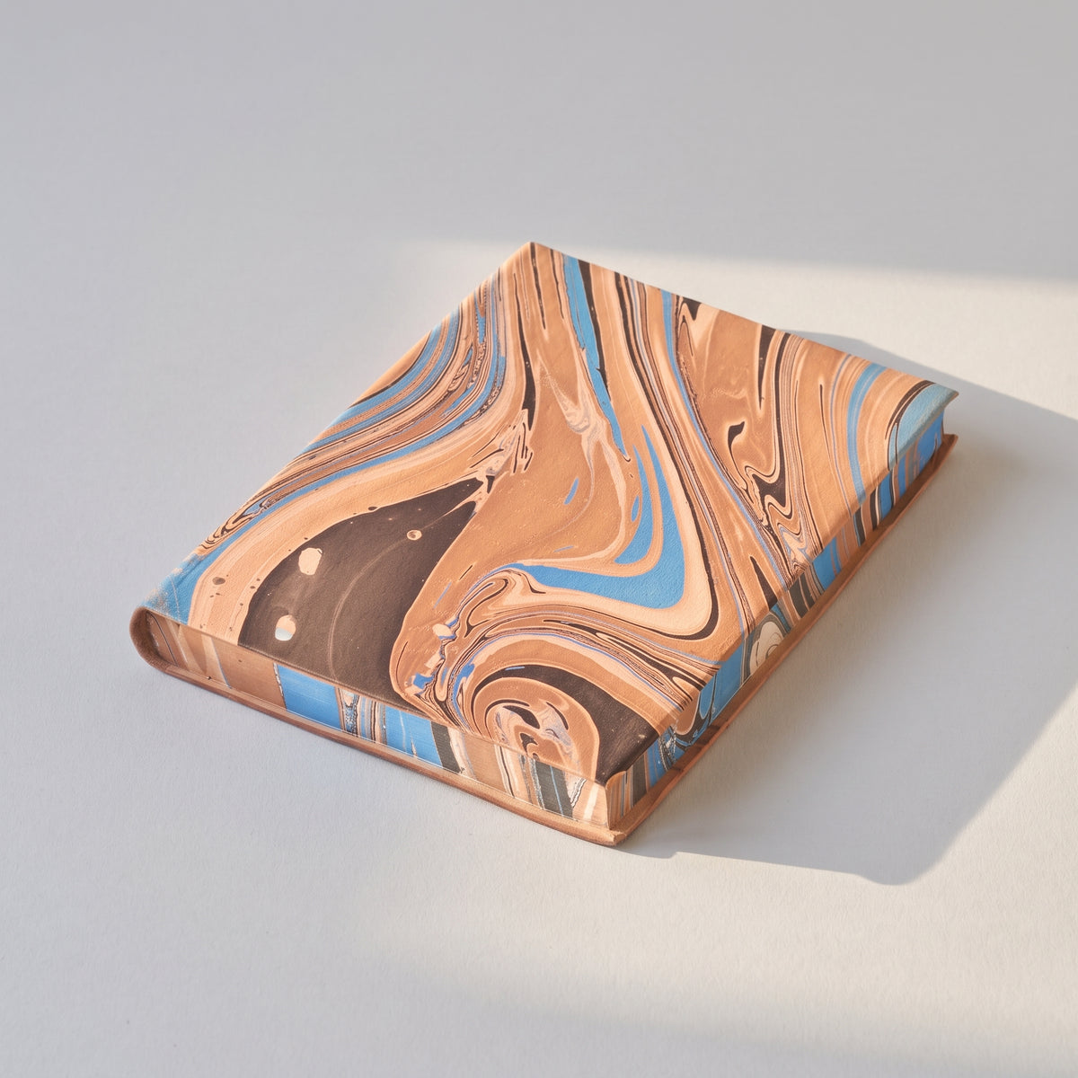 Another angle of the Hand-Marbled Leather Journal showing the cover and binding