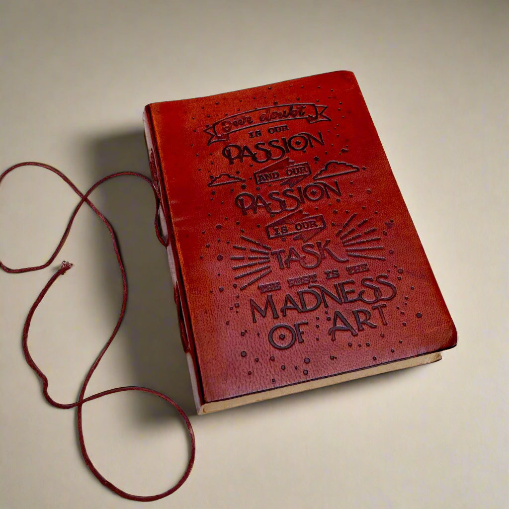 Front cover of the Henry James Our Doubt Is Our Passion Leather Journal showing debossed Henry James quote over an intricate leather background