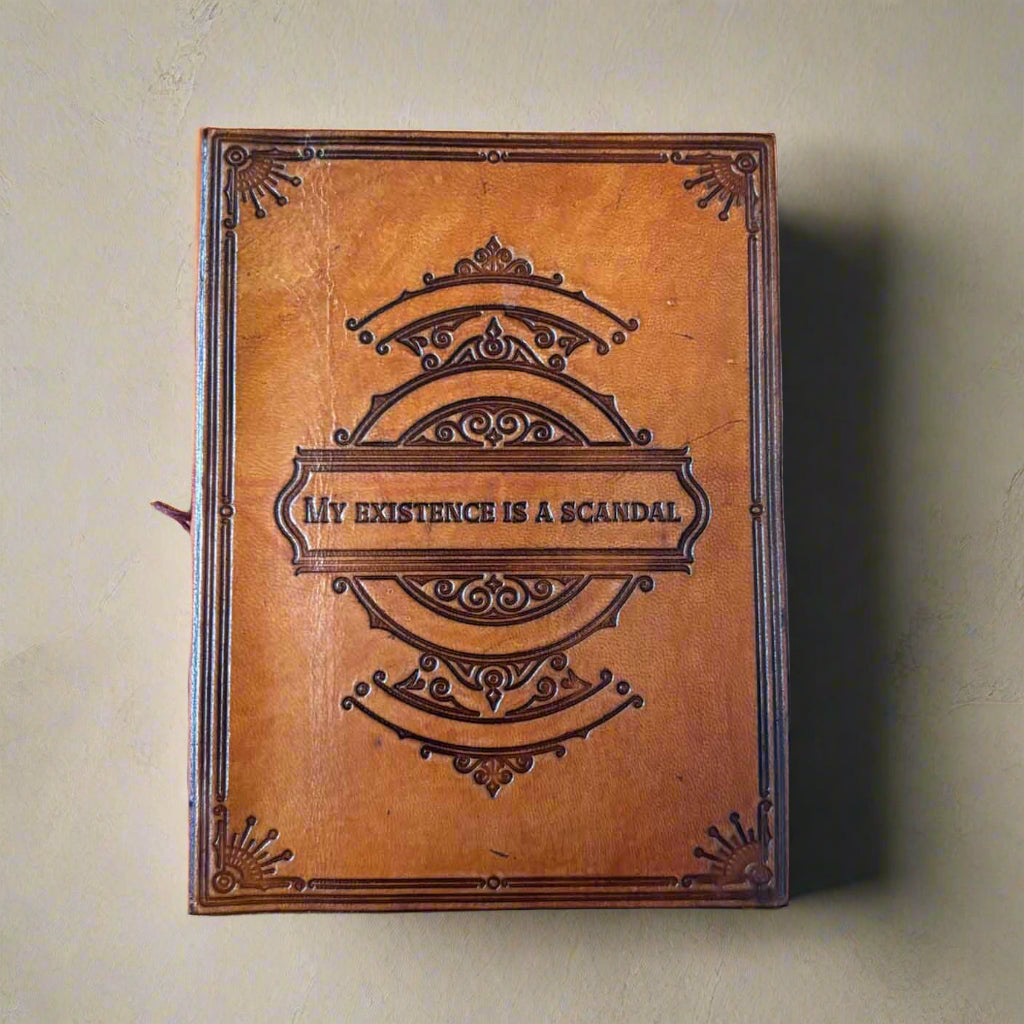 Brown leather-bound book with embossed design and text on a brown background