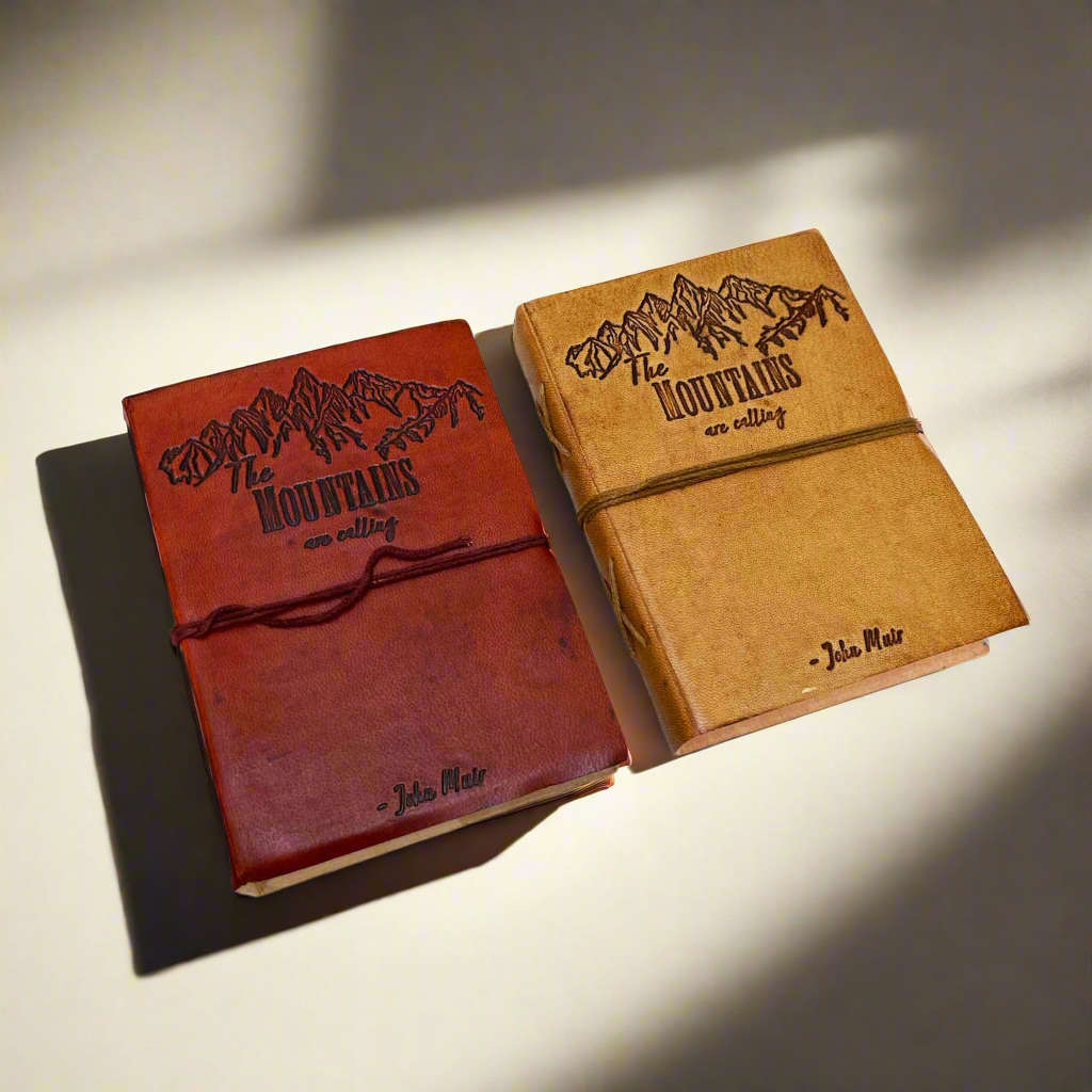 Different angle of the John Muir Mountains Are Calling Leather Journal showing the cover and page edges