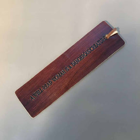 Wooden bookmark with engraved text on a light gray background
