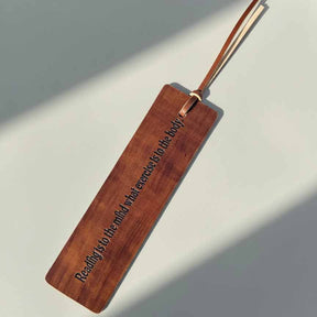 Leather bookmark with engraved text on a light background