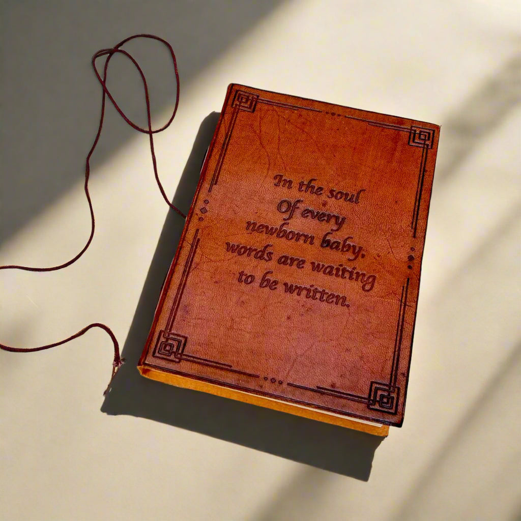 Front cover of the Newborn Baby Words Are Waiting Leather Journal showing debossed newborn quote inside a geometric leather frame