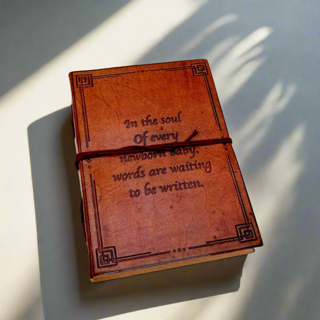 Another angle of the Newborn Baby Words Are Waiting Leather Journal showing the cover and binding