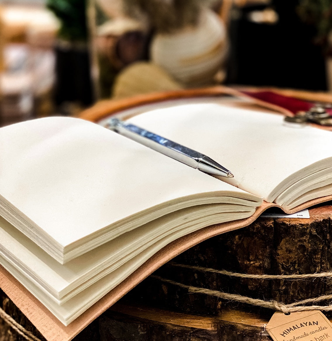Floral Debossed Latch Leather Journal open to handmade tree-free paper