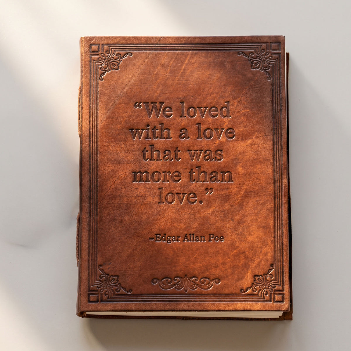 A Love More Than Love brown leather journal photographed from a different angle