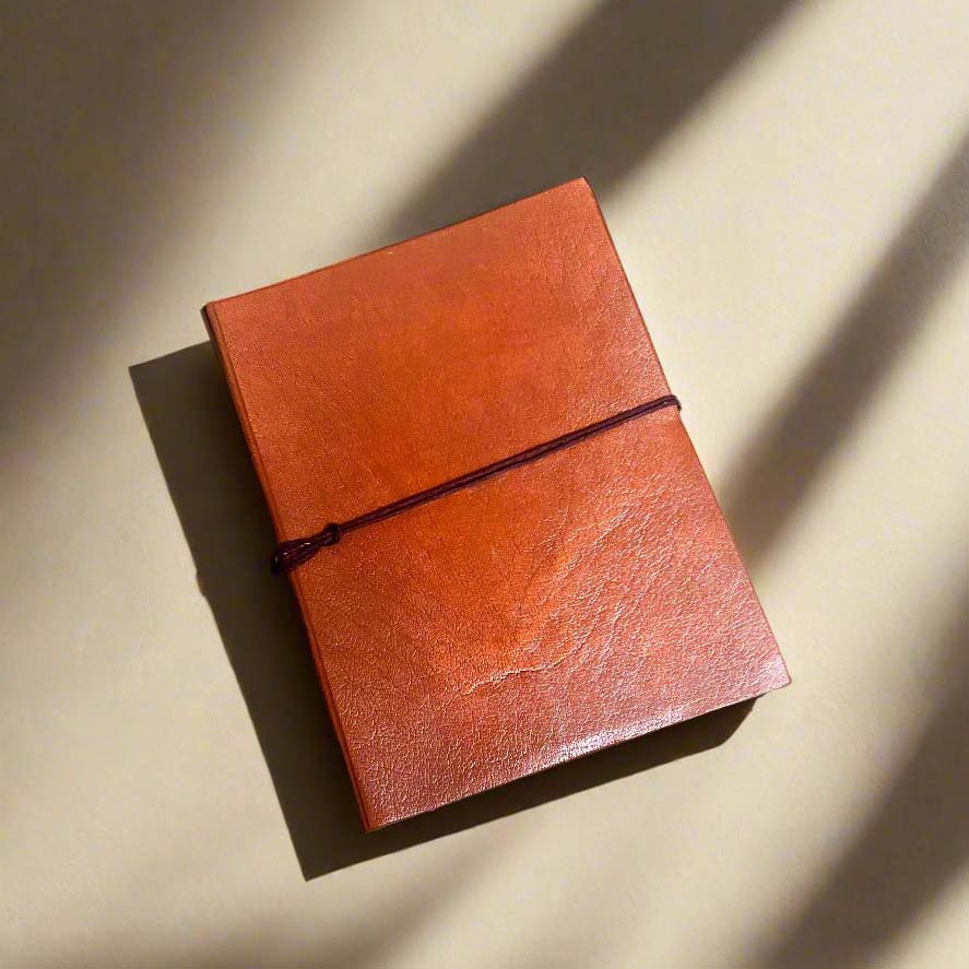 Tangerine Plain Cover Leather Journal with lined pages, 6 x 8 inches.