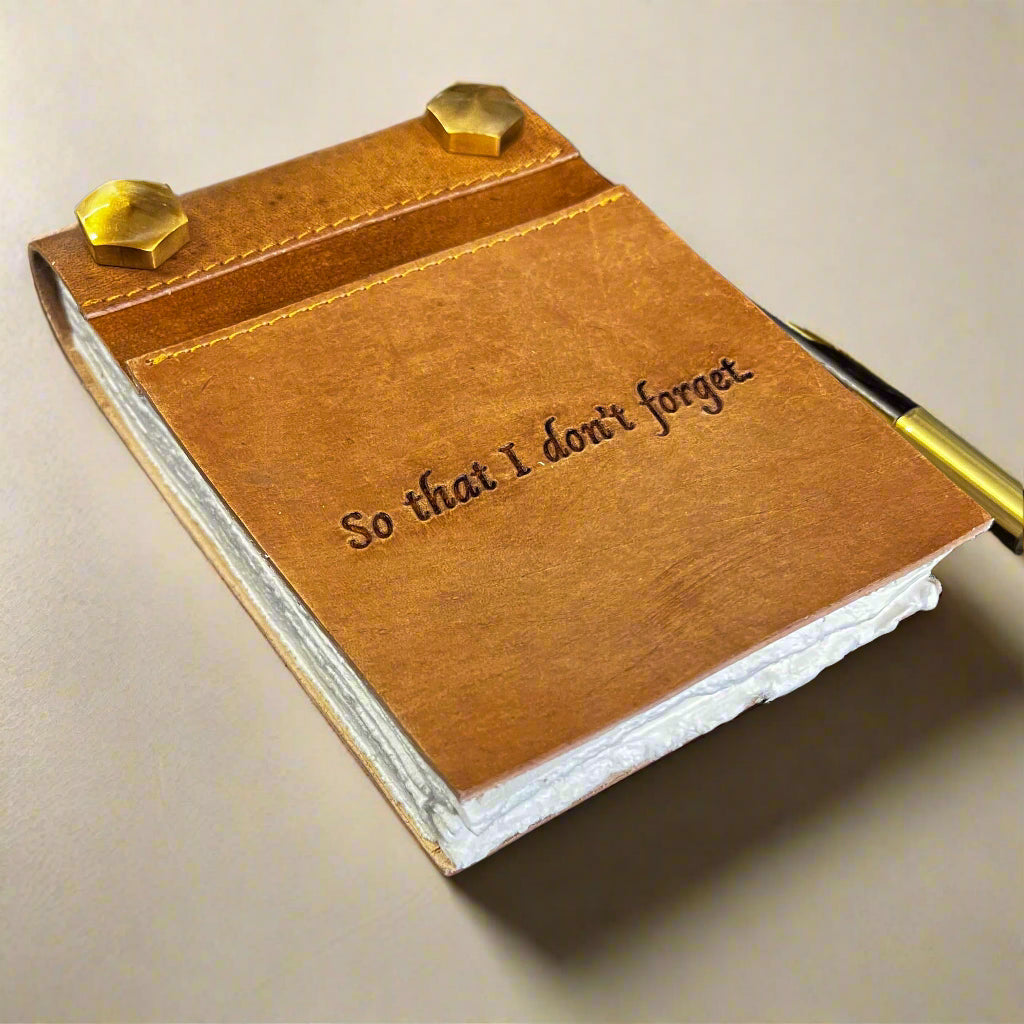 Tan leather notepad open to unlined handmade paper