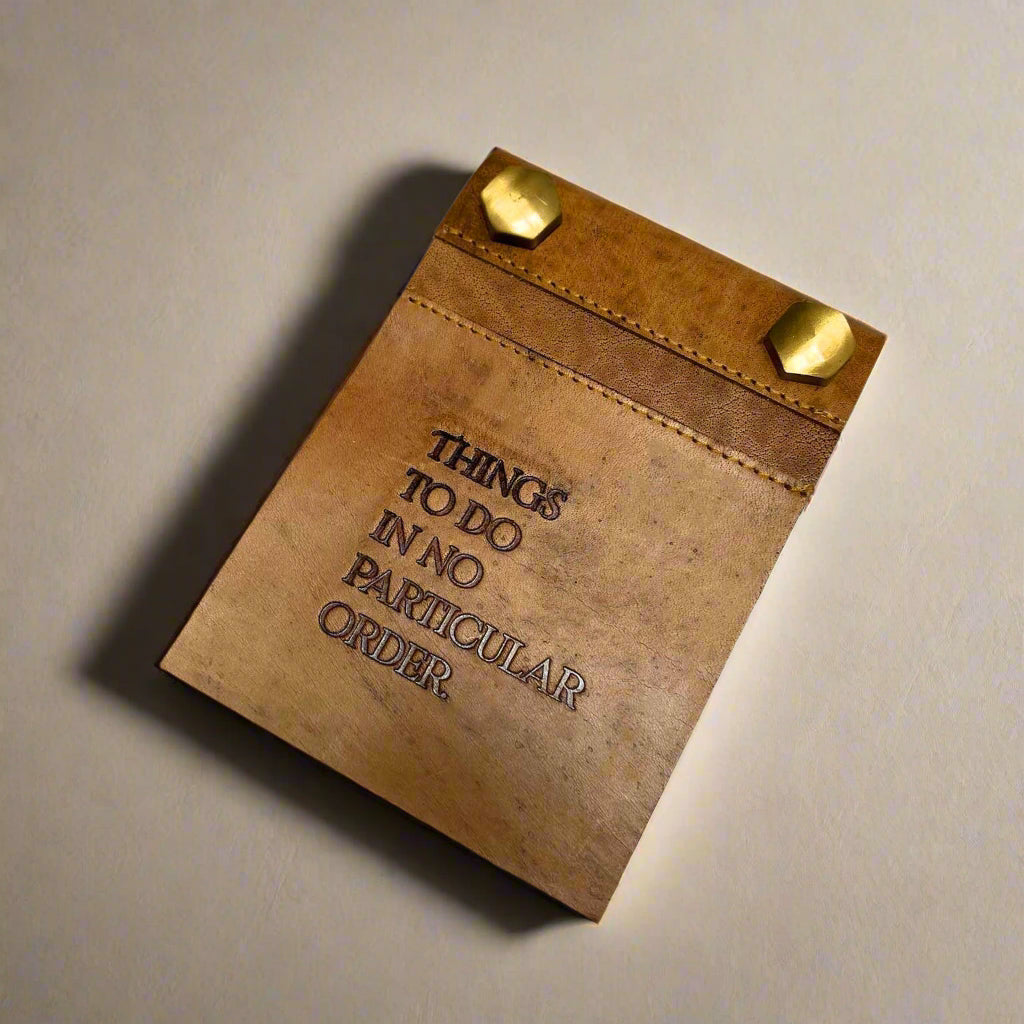 Screw-post binding detail on refillable leather notepad