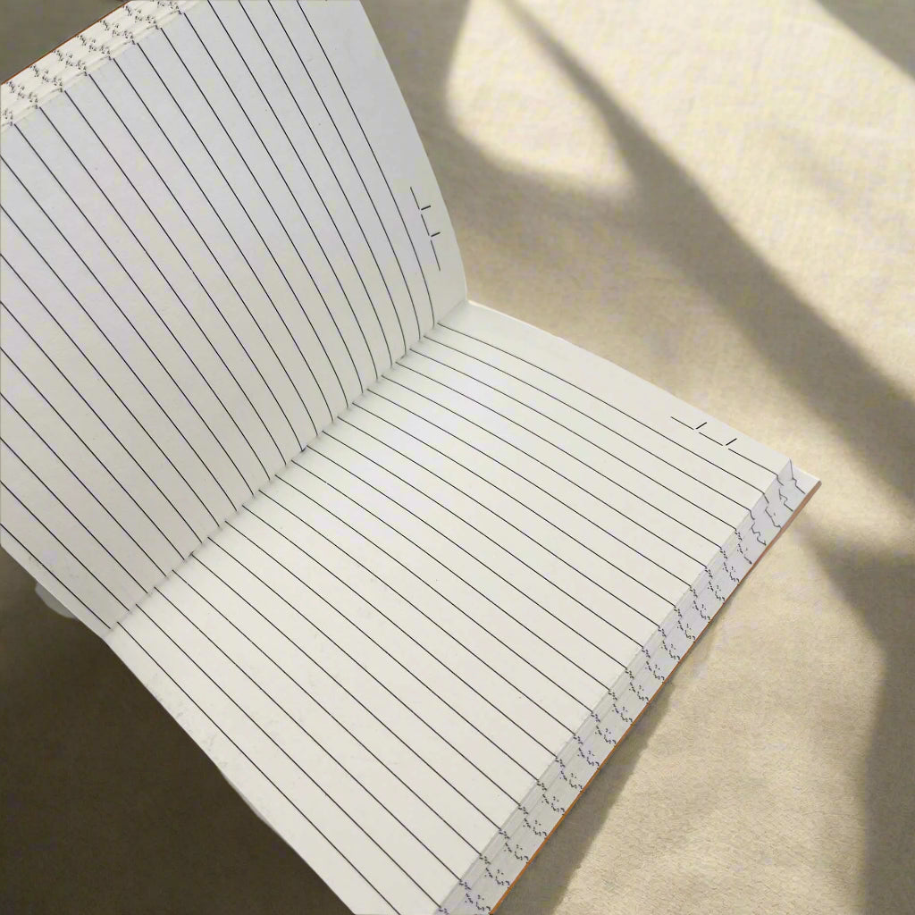 If A Story 8x6 leather journal open to lined cotton-waste paper pages