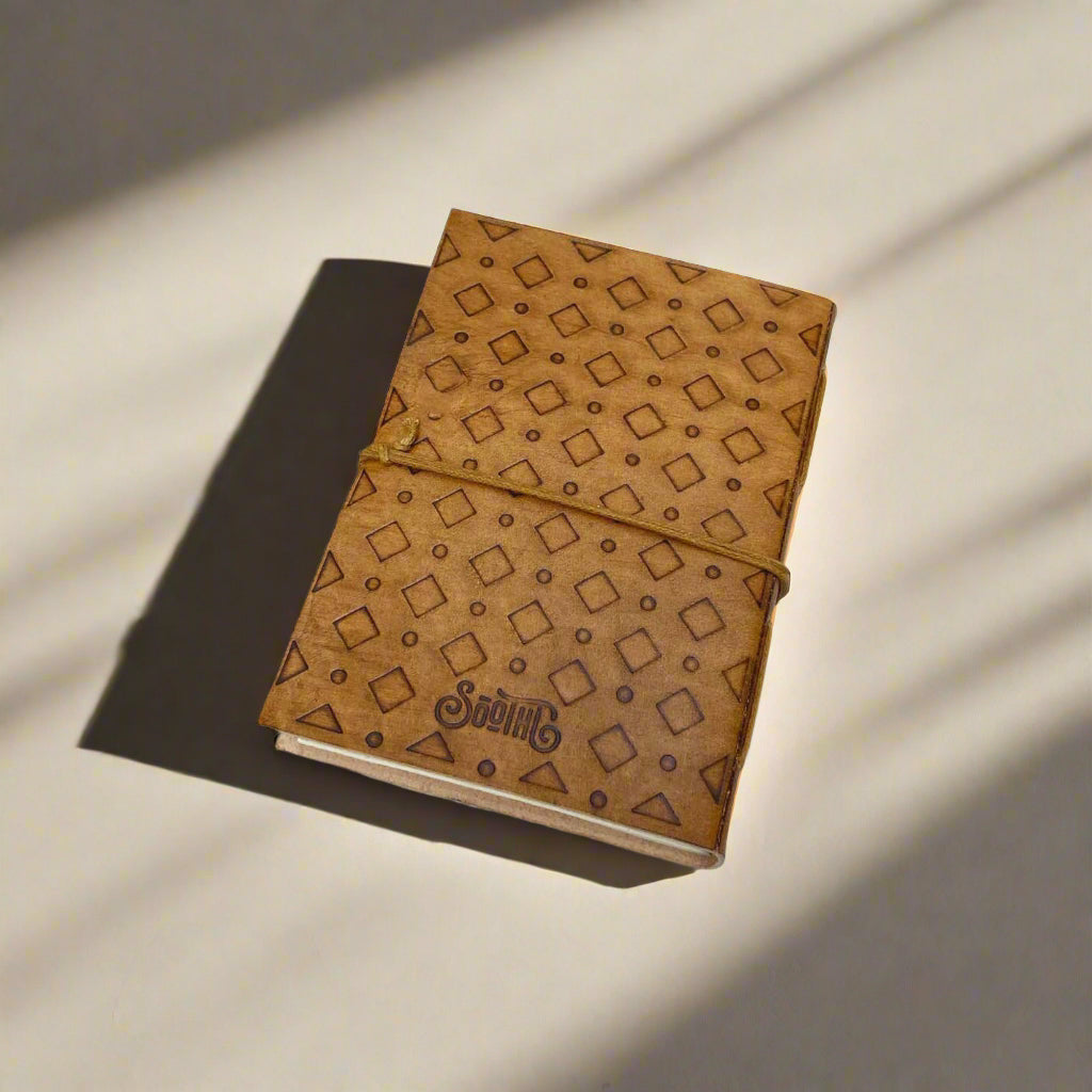 Close-up of She Persisted tan leather journal cover