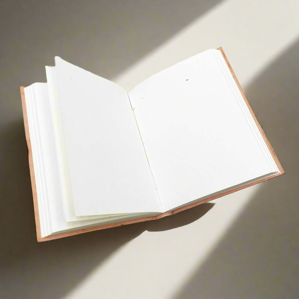 Leather journal showing stitched spine and handmade paper edges