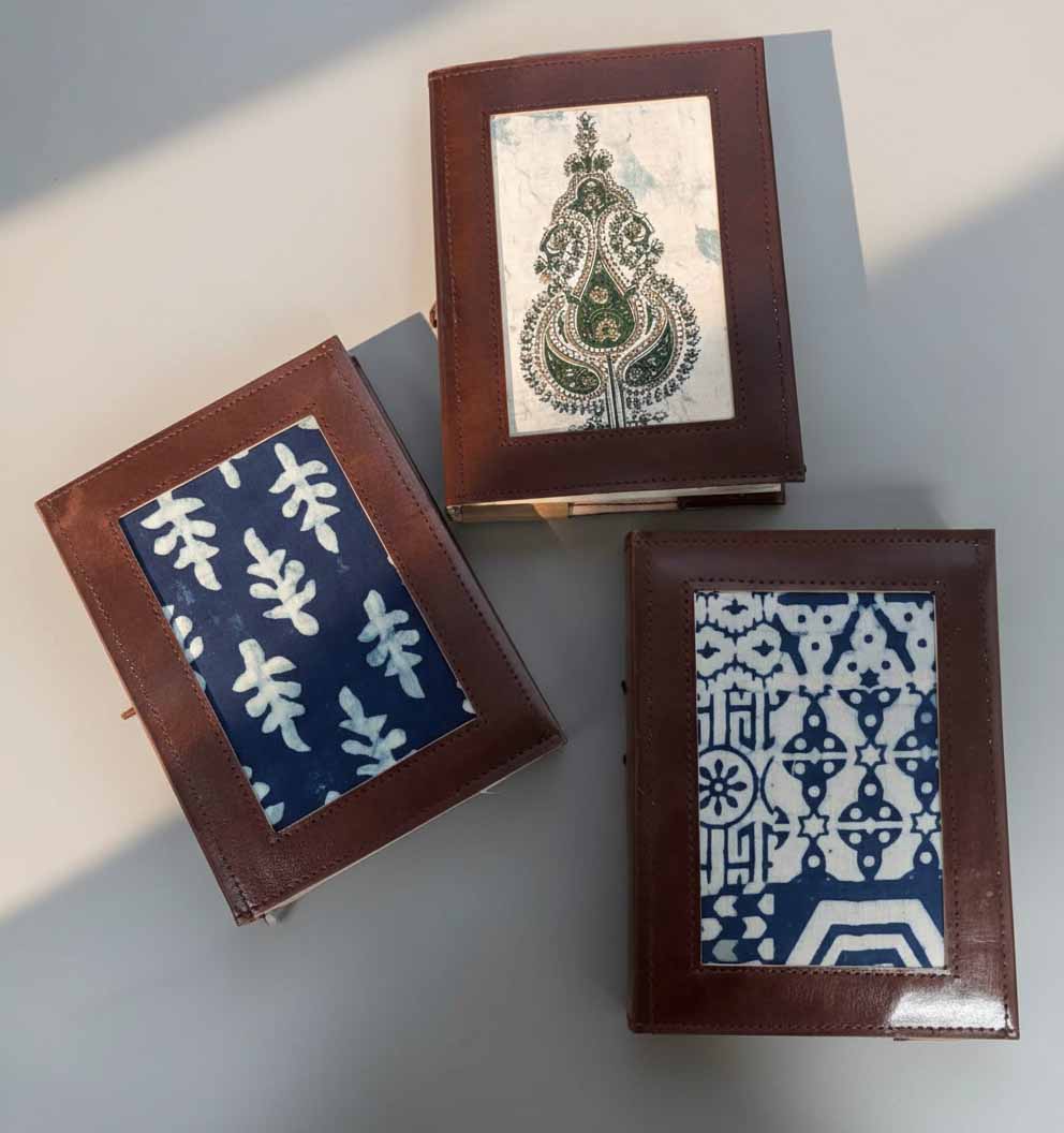 Close-up of three Legacy Patchwork artisan fabric leather journals-1