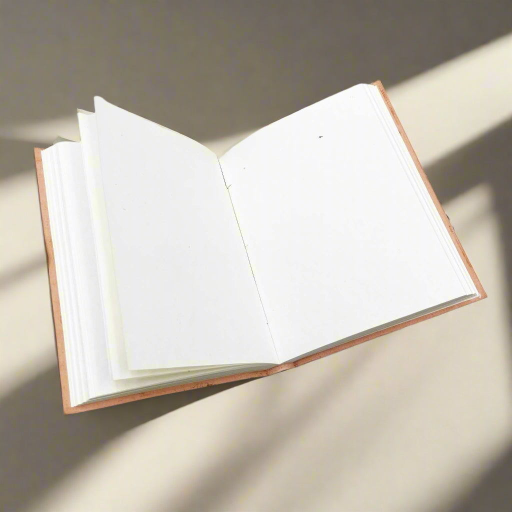Leather journal showing stitched spine and handmade paper edges