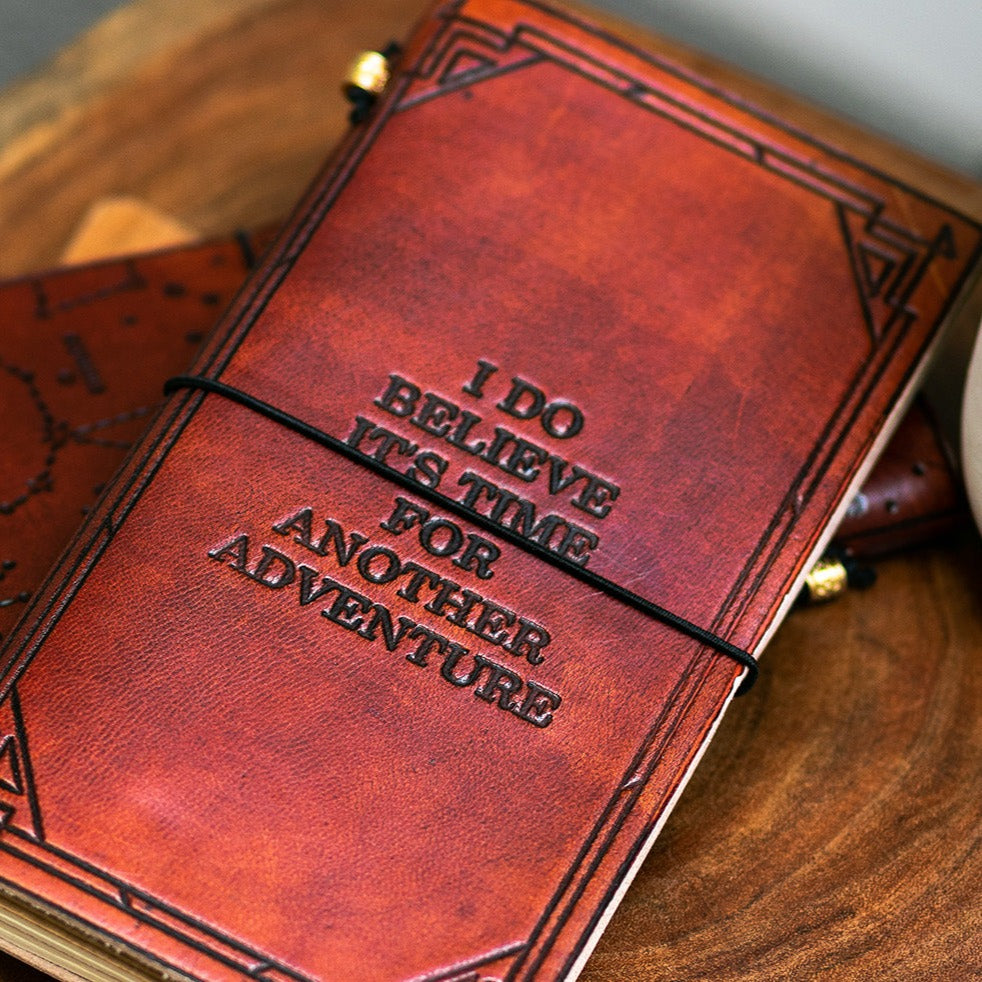 Debossed adventure quote on brown leather traveler's notebook cover
