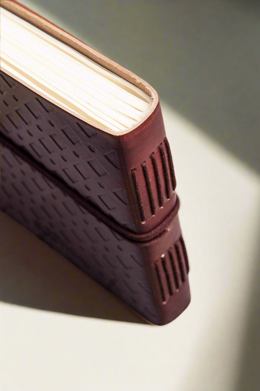 Compass 7x7 leather journal open to unlined tree-free paper pages