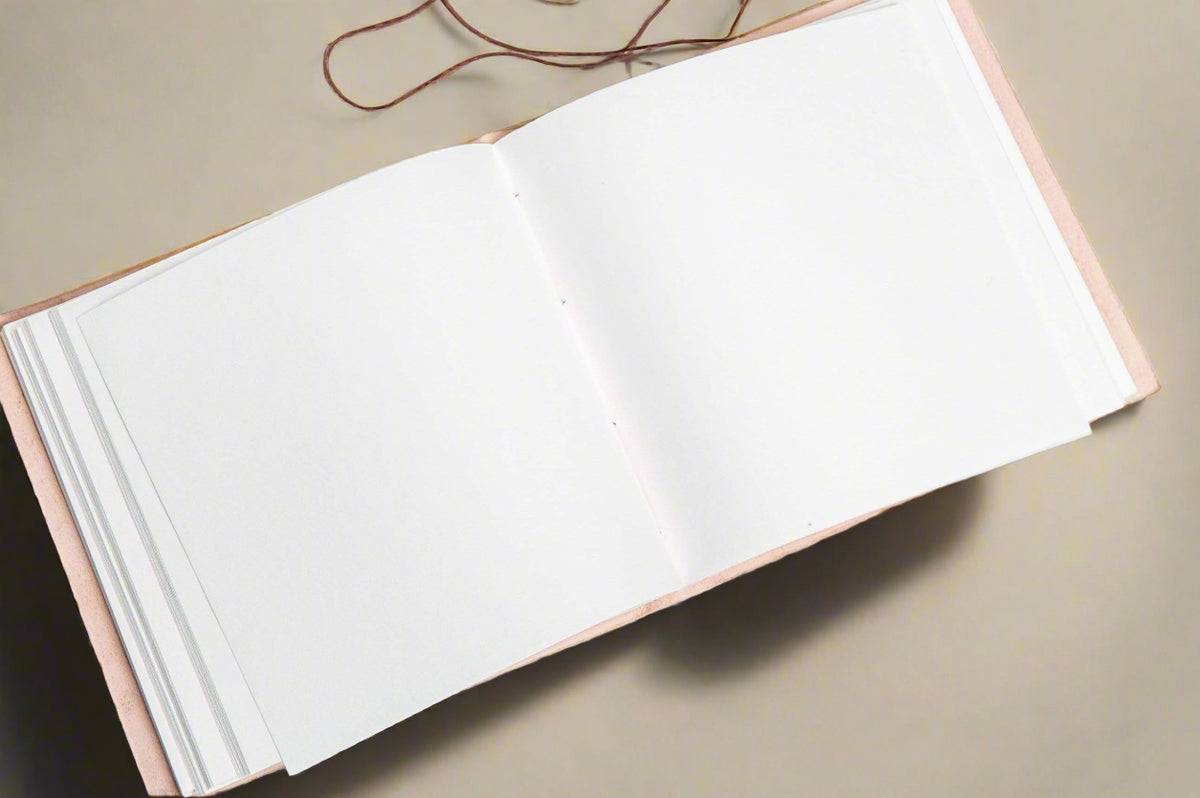 Open 7x7 leather journal showing unlined pages